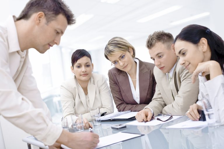 Photo: team at work on a project, but one team member seems unsure